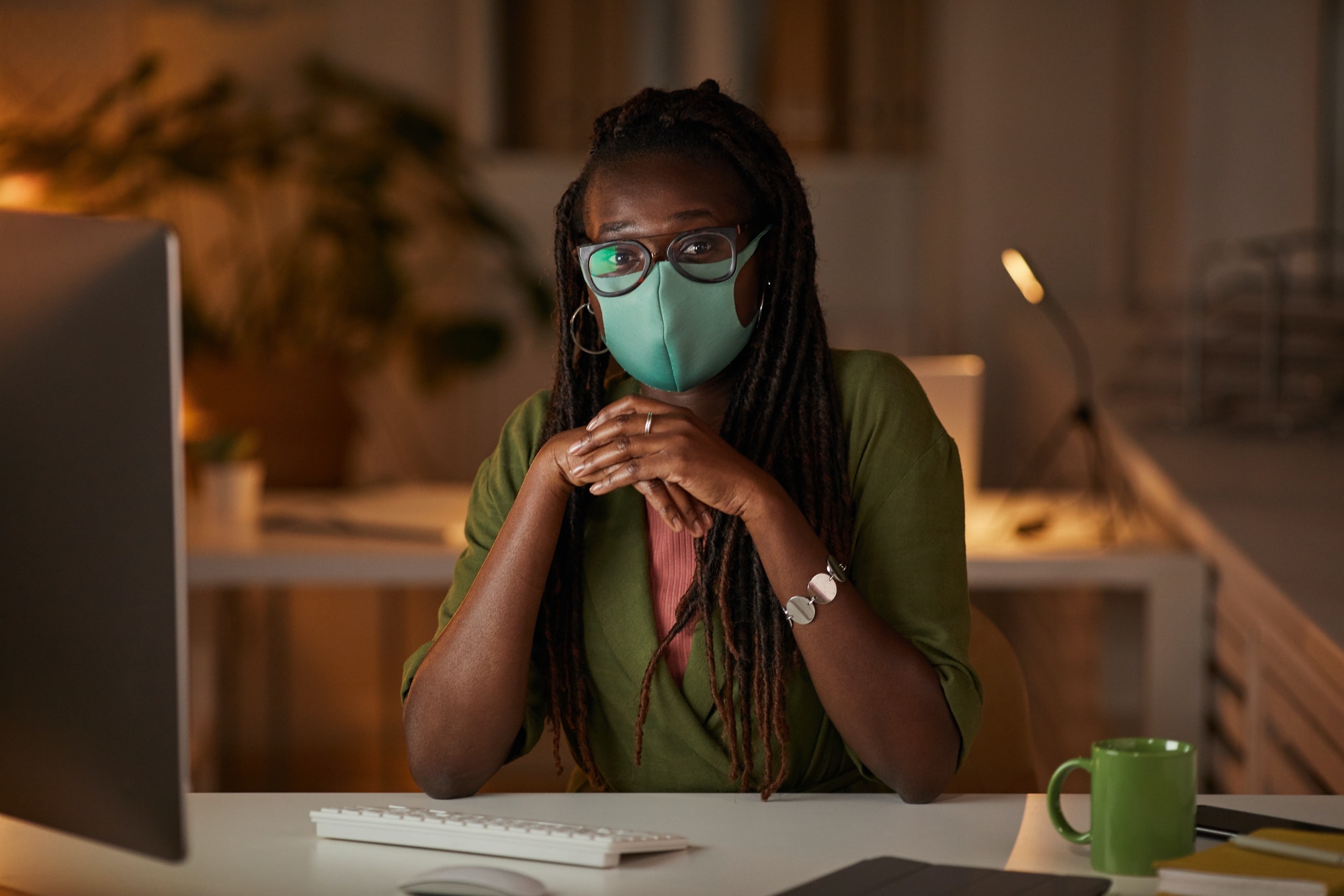 African Businesswoman Wearing Mask in Office